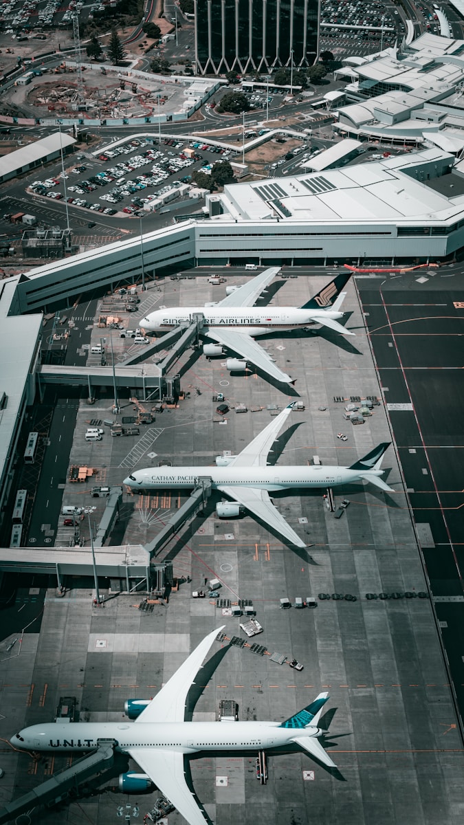 white and gray airplane on airport during daytime